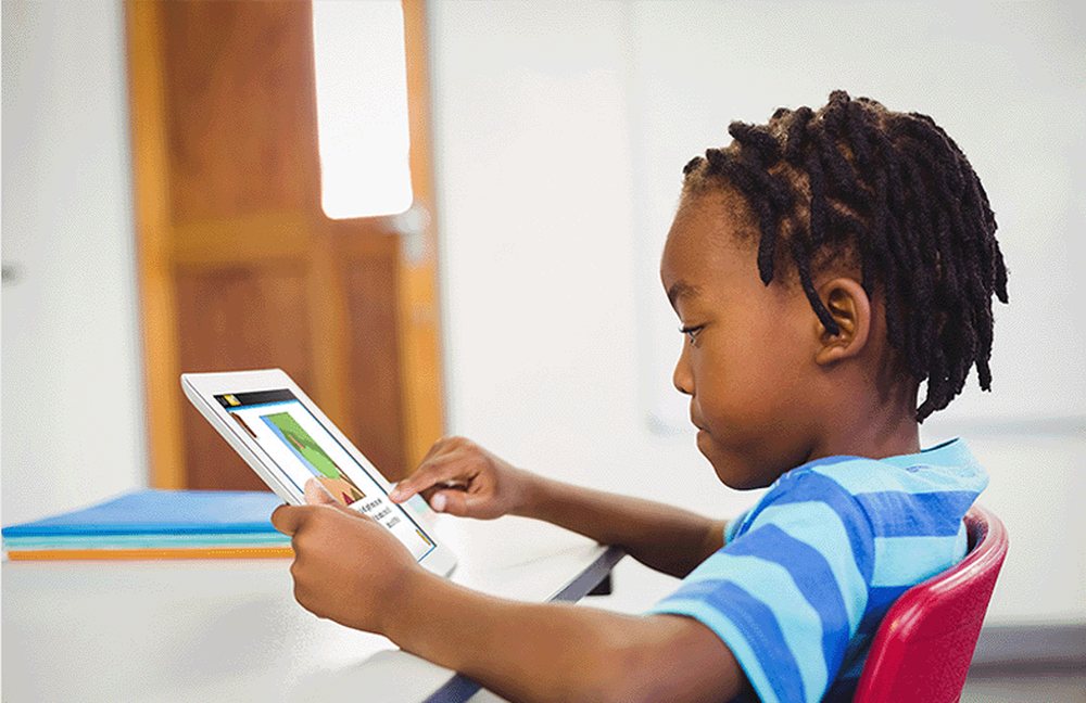 A boy using Reading Kingdom on a tablet